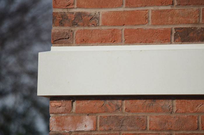 Indiana limestone banding string course on masonry wall exterior, Tulip Precast