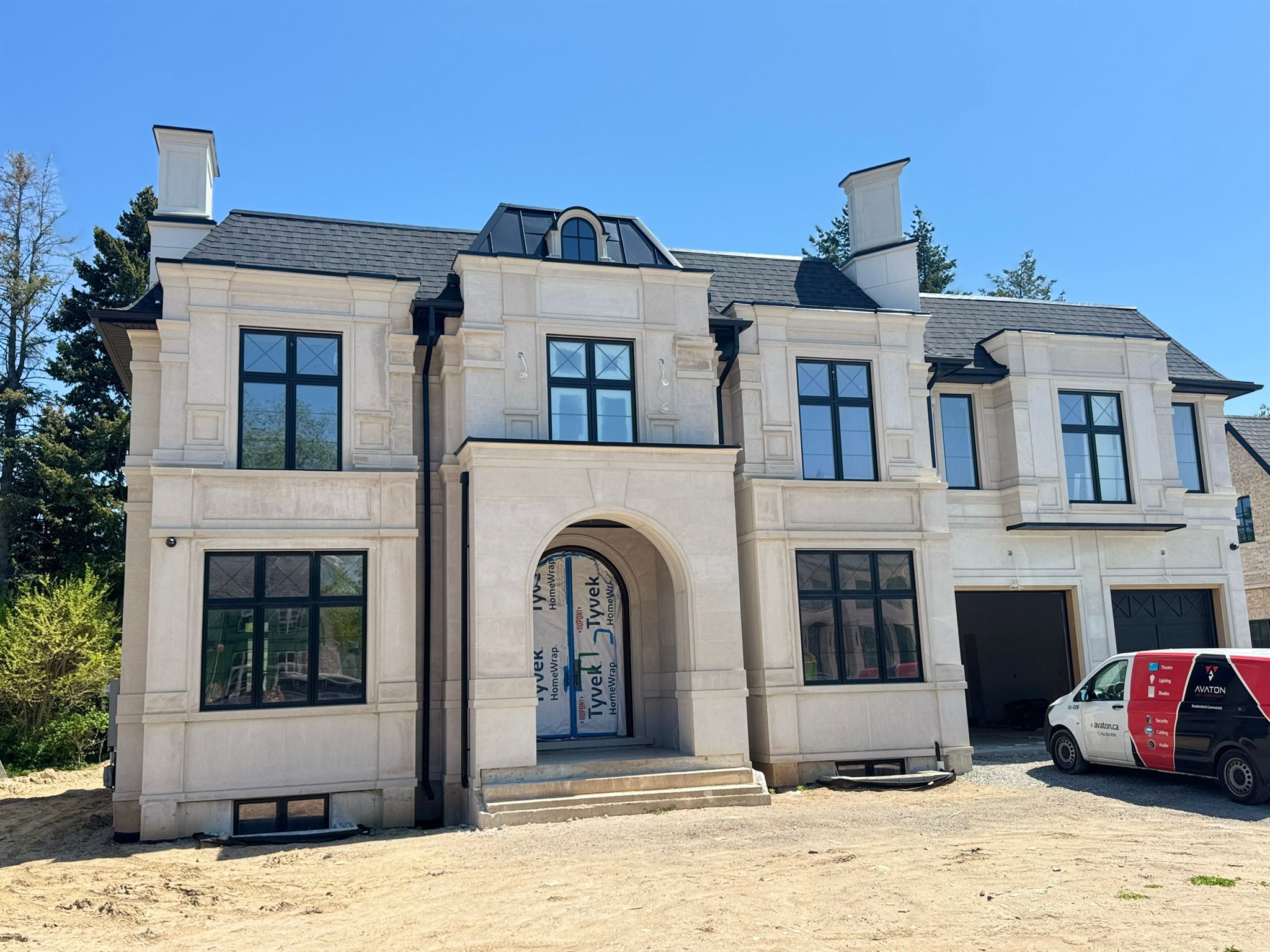 Grand Beaux-Arts limestone estate with mansard roof and columns